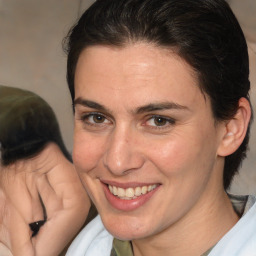 Joyful white adult female with medium  brown hair and brown eyes