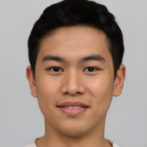 Joyful asian young-adult male with short  black hair and brown eyes