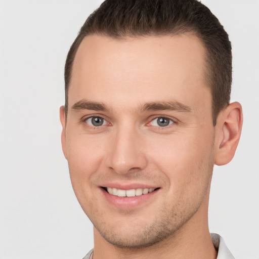 Joyful white young-adult male with short  brown hair and brown eyes