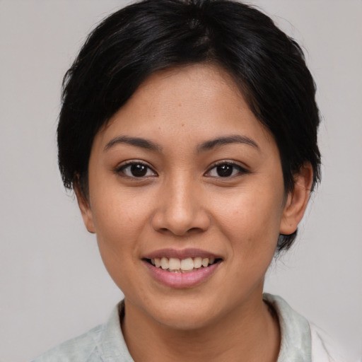Joyful asian young-adult female with medium  black hair and brown eyes