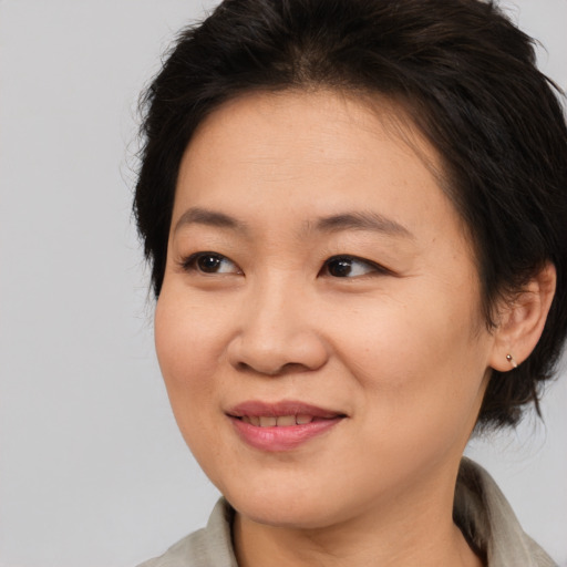 Joyful asian young-adult female with medium  brown hair and brown eyes