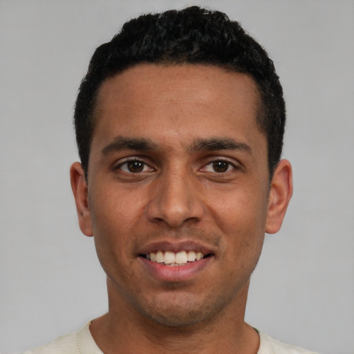 Joyful white young-adult male with short  black hair and brown eyes