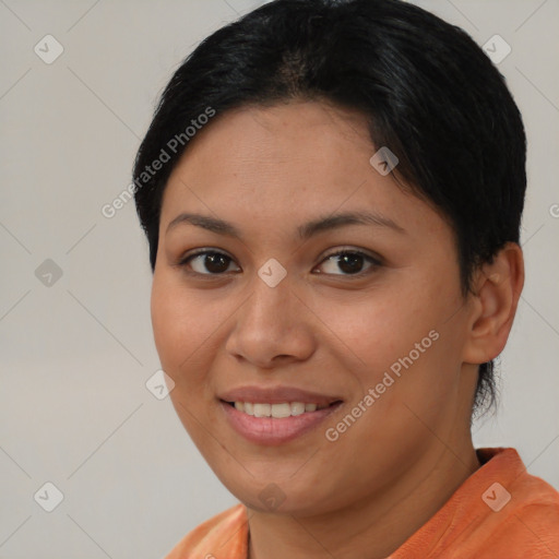 Joyful asian young-adult female with short  brown hair and brown eyes