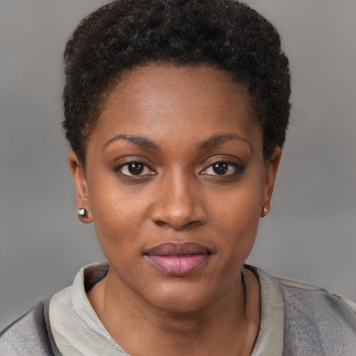 Joyful black young-adult female with short  brown hair and brown eyes