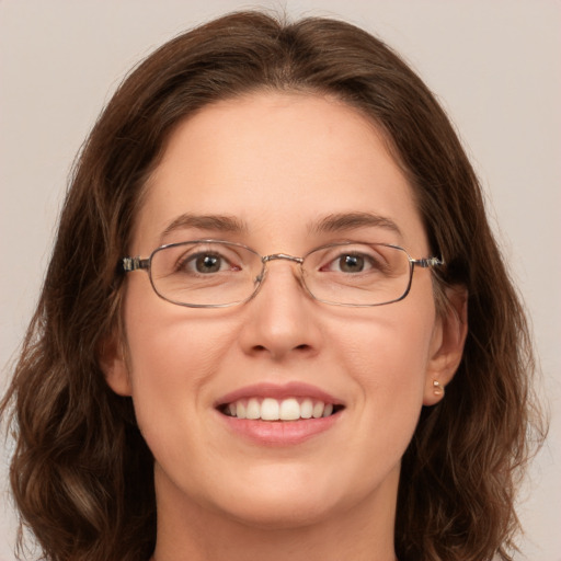 Joyful white adult female with long  brown hair and green eyes