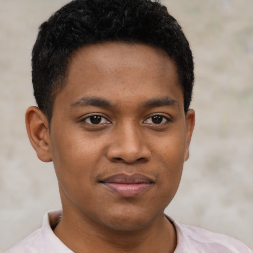 Joyful black young-adult male with short  black hair and brown eyes