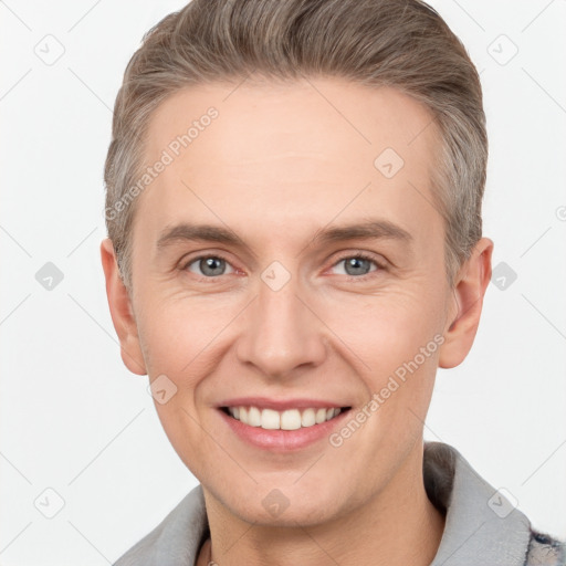 Joyful white adult male with short  brown hair and grey eyes