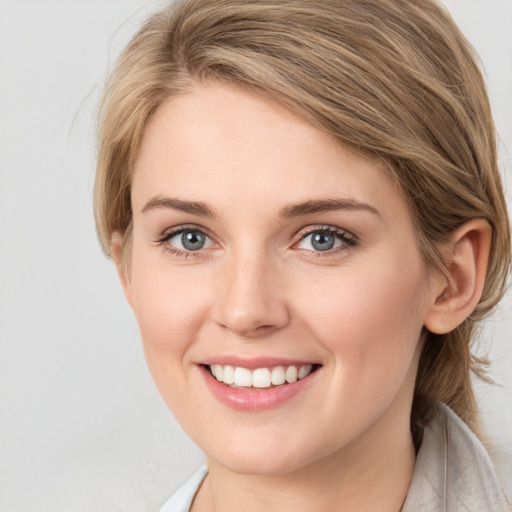 Joyful white young-adult female with medium  brown hair and green eyes