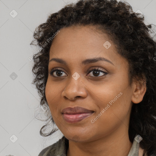 Joyful black young-adult female with long  brown hair and brown eyes