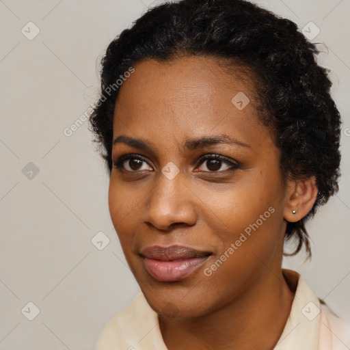 Joyful black young-adult female with short  black hair and brown eyes