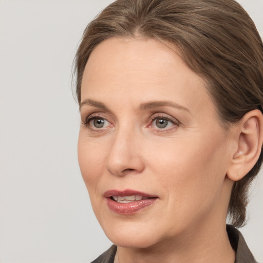 Joyful white adult female with medium  brown hair and brown eyes