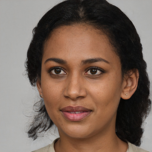 Joyful black young-adult female with medium  black hair and brown eyes