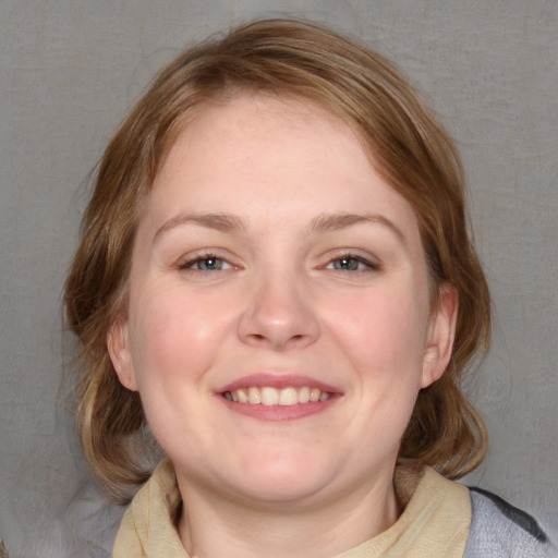 Joyful white young-adult female with medium  brown hair and blue eyes