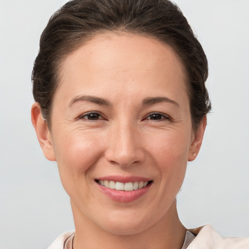 Joyful white adult female with short  brown hair and brown eyes