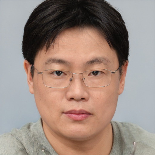 Neutral asian adult male with short  brown hair and brown eyes