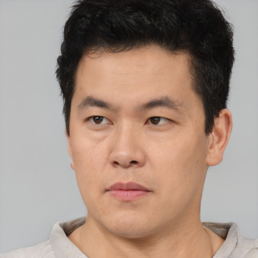 Neutral asian young-adult male with short  brown hair and brown eyes