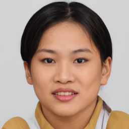 Joyful asian young-adult female with short  brown hair and brown eyes