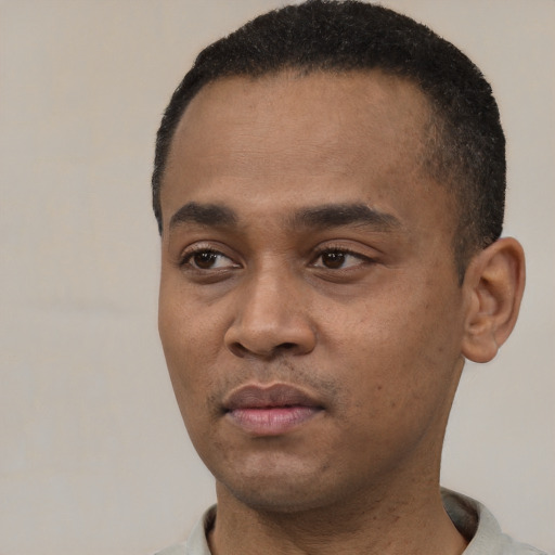 Neutral latino young-adult male with short  black hair and brown eyes