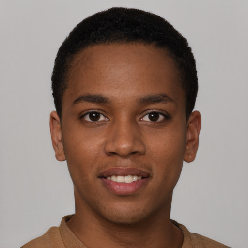 Joyful black young-adult male with short  brown hair and brown eyes