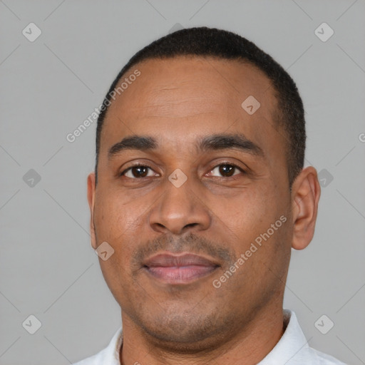 Neutral latino adult male with short  black hair and brown eyes