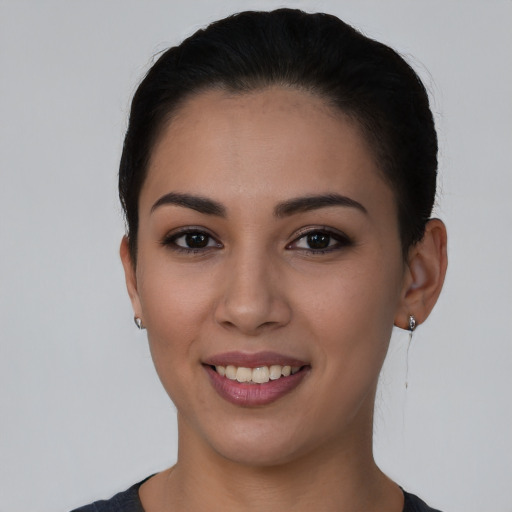 Joyful white young-adult female with short  black hair and brown eyes