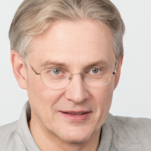 Joyful white middle-aged male with short  brown hair and blue eyes