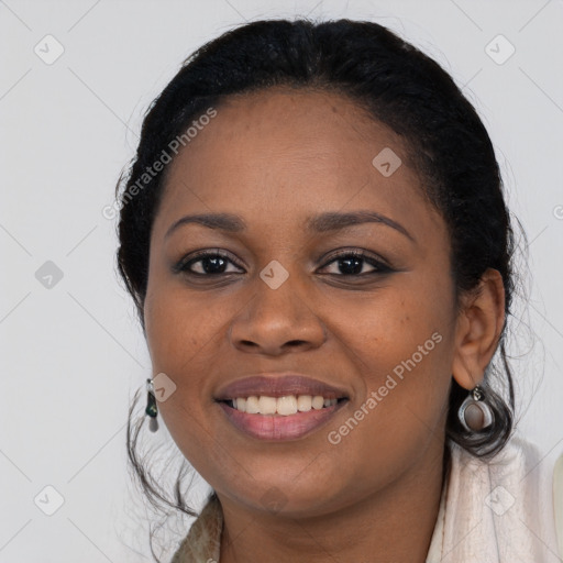 Joyful black young-adult female with long  black hair and brown eyes