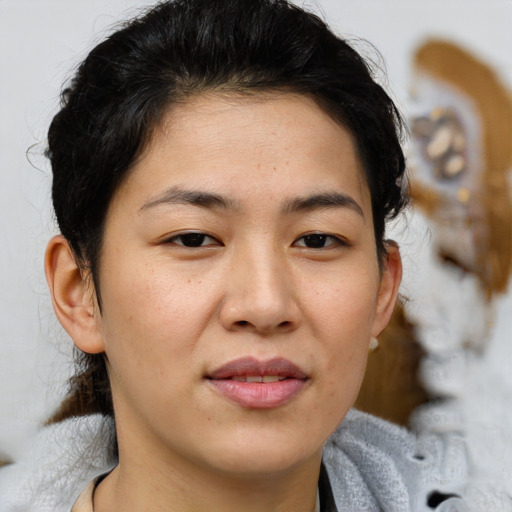 Joyful asian young-adult female with medium  brown hair and brown eyes