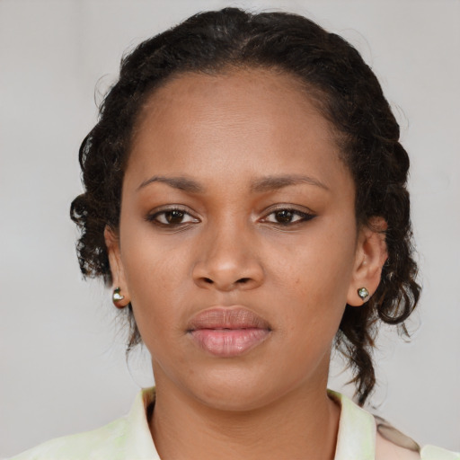 Neutral black young-adult female with medium  brown hair and brown eyes