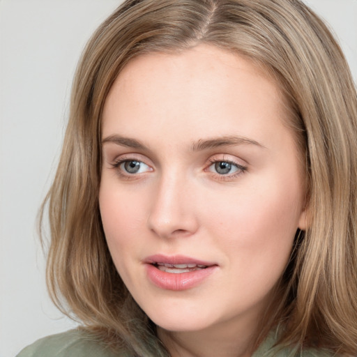 Joyful white young-adult female with long  brown hair and blue eyes