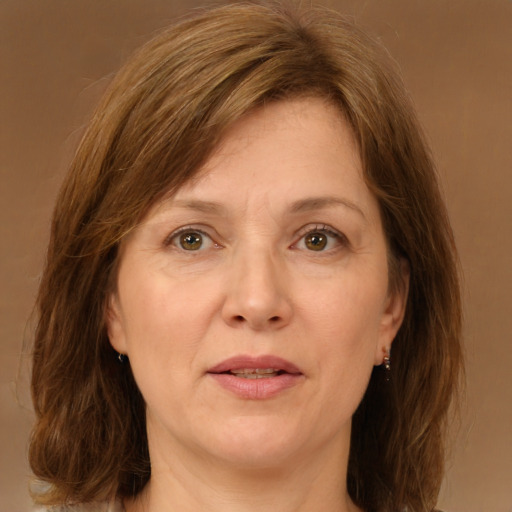 Joyful white adult female with medium  brown hair and green eyes