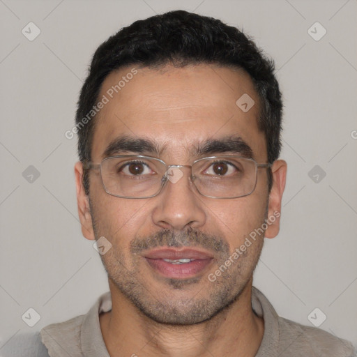 Joyful white adult male with short  black hair and brown eyes