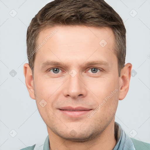 Joyful white young-adult male with short  brown hair and grey eyes