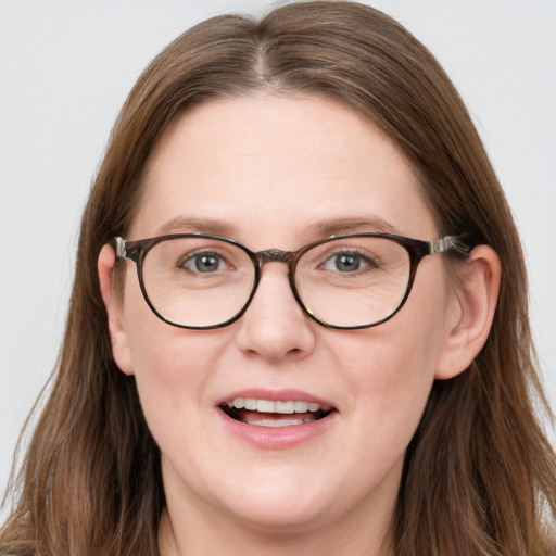 Joyful white adult female with long  brown hair and blue eyes