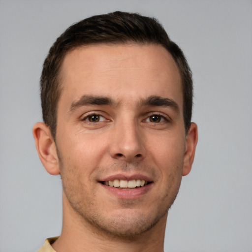 Joyful white young-adult male with short  brown hair and brown eyes