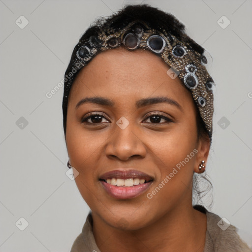 Joyful black young-adult female with long  black hair and brown eyes