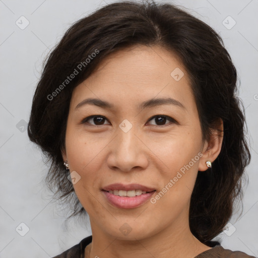 Joyful asian adult female with medium  brown hair and brown eyes