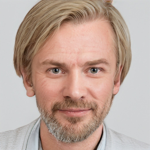 Joyful white adult male with short  brown hair and blue eyes