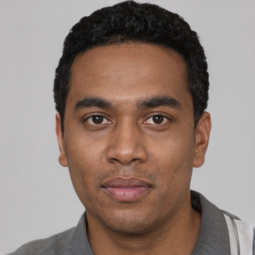 Neutral black young-adult male with short  black hair and brown eyes