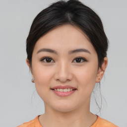 Joyful asian young-adult female with medium  brown hair and brown eyes