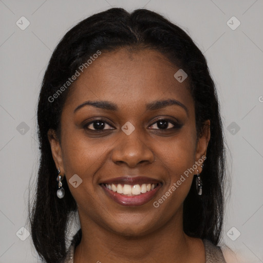 Joyful black young-adult female with long  brown hair and brown eyes