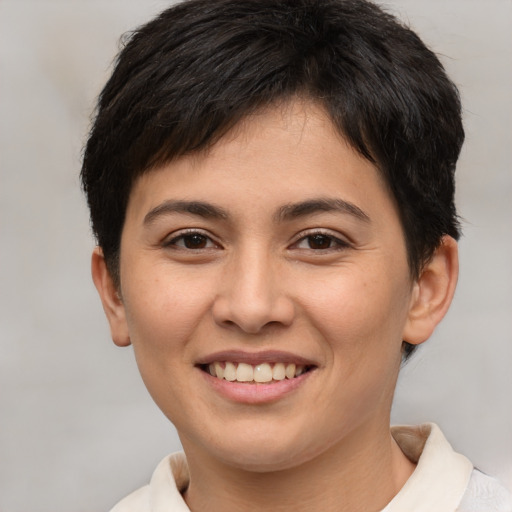 Joyful white young-adult female with short  brown hair and brown eyes