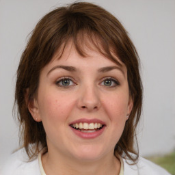 Joyful white young-adult female with medium  brown hair and blue eyes