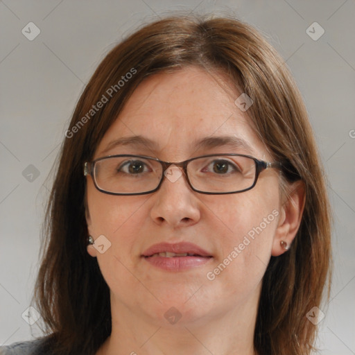 Joyful white adult female with medium  brown hair and blue eyes