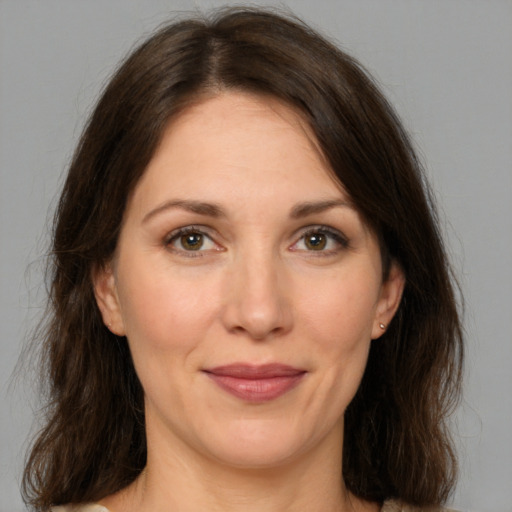 Joyful white adult female with medium  brown hair and brown eyes