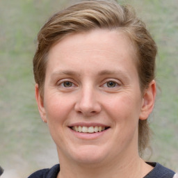 Joyful white young-adult female with medium  brown hair and blue eyes