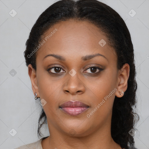 Joyful black young-adult female with long  brown hair and brown eyes