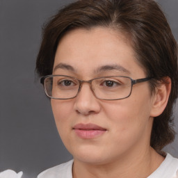 Joyful white adult female with medium  brown hair and brown eyes