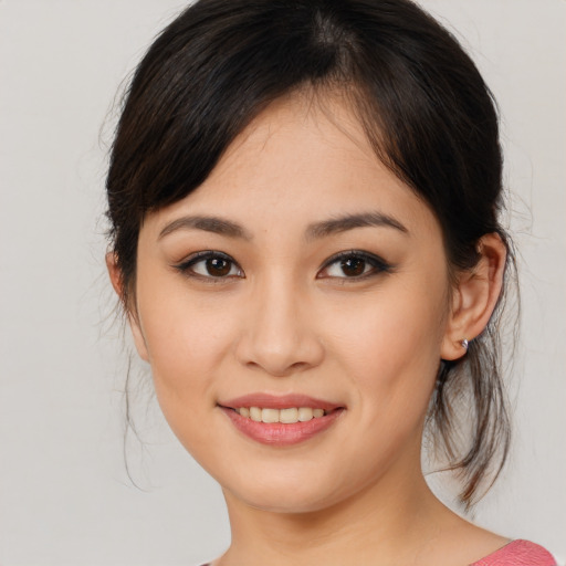 Joyful asian young-adult female with medium  brown hair and brown eyes