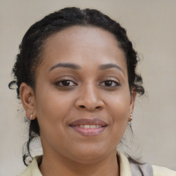 Joyful black young-adult female with medium  brown hair and brown eyes